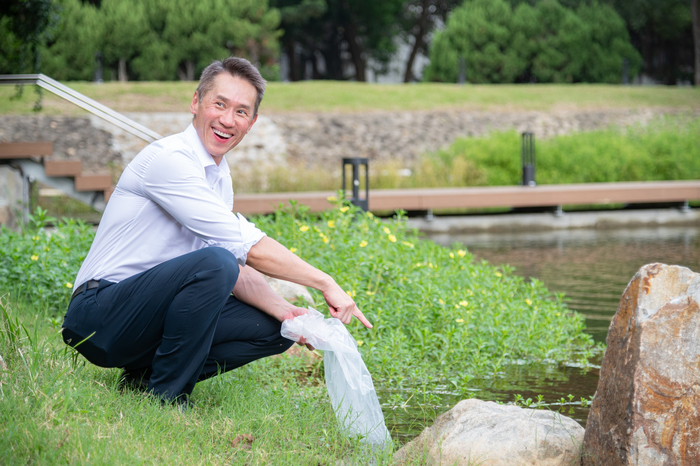 清華大學校長高為元施放魚苗到成功湖中。