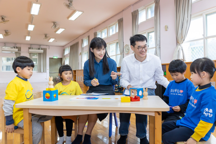 清華幼教系特聘教授周育如(左三)與生科系副教授郭崇涵(右三)引導幼兒在遊戲中合作。圖片